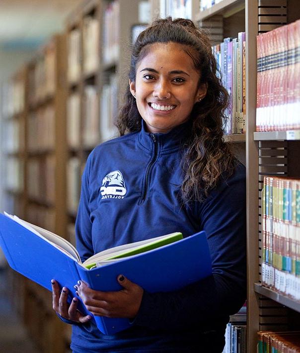 student holding book